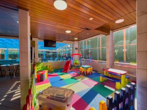 a childrens room with a play area with toys at Hotel Palazzo Reale in Campos do Jordão