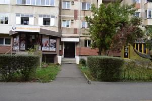 a building with a sign on the front of it at Apartament Modest Traian RHBM in Baia Mare