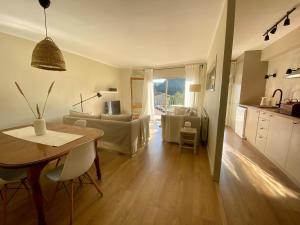 a kitchen and living room with a table and a couch at Can Guasch in Camprodon