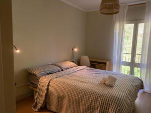 a bedroom with a bed with a checkered blanket at Can Guasch in Camprodon