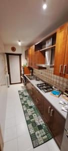 a kitchen with wooden cabinets and a stove top oven at Regina Ciclarum Suite in Fiumicino