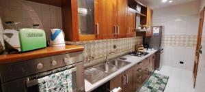 a kitchen with a sink and a counter top at Regina Ciclarum Suite in Fiumicino