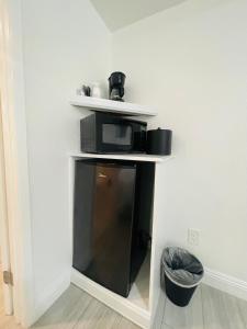 a microwave sitting on a shelf in a room at Loma Linda Inn in San Bernardino