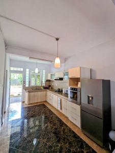 a large kitchen with stainless steel appliances at Villa Coco - Flic en Flac in Flic-en-Flac