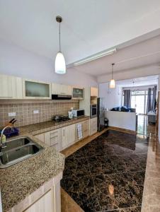 a kitchen with a sink and a counter top at Villa Coco - Flic en Flac in Flic-en-Flac