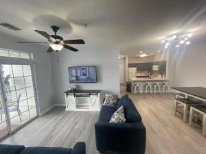 ein Wohnzimmer mit einer Couch und einem Deckenventilator in der Unterkunft Home sweet Home near Disneyland in Kissimmee