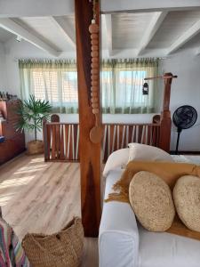 a living room with a bed and a couch at Casa América in Parnaíba
