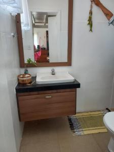a bathroom with a sink and a mirror at Casa América in Parnaíba