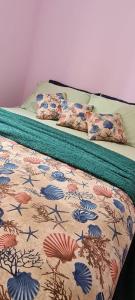 2 camas num quarto com uma colcha com conchas do mar em Conforto e Lazer na Enseada no Guarujá