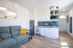 a living room with a couch and a kitchen at Great Ocean View Torviscas Beach Home by LoveTenerife in Adeje