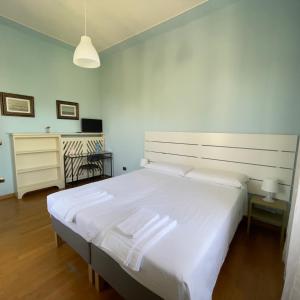 1 dormitorio con 1 cama blanca grande y escritorio en Villa Peonia Parma en Parma