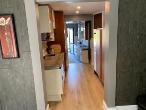 a kitchen with white cabinets and a wooden floor at Seventy Eight in Wexford