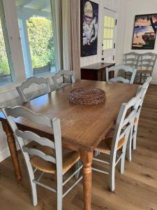 a dining room table with chairs and a wooden table at laguna beach cottage home in Laguna Beach
