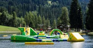 a group of inflatable play structures in the water at Luxury Chalet Morzine with stunning mountain views in Saint-Jean-d'Aulps
