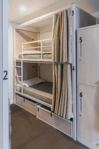 an empty room with two bunk beds in it at The Social Hotel, Sydney in Sydney