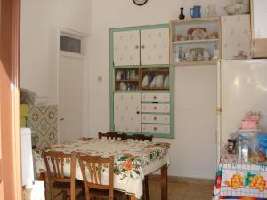 a dining room with a table and some cabinets at Villa Elena in Lindos