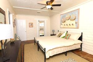 a bedroom with a bed and a ceiling fan at Cozy Adobe in Pahrump
