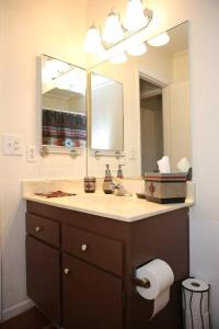 a bathroom with a sink and a mirror at Cozy Adobe in Pahrump