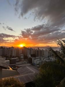 a view of a city with the sunset in the background at Casas de Floripa in Florianópolis