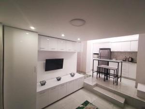 a kitchen with white cabinets and a table in it at Loft VIP in Naama bey in Sharm El Sheikh