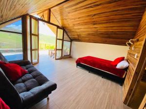 a living room with a couch and a large window at CABAÑAS EL PARAISO PESCADERITO in Curití