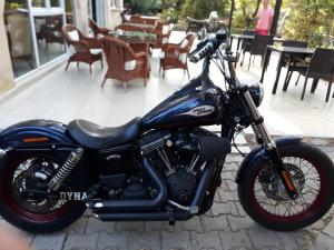 a blue motorcycle parked in front of a restaurant at Lapida Garden in Kyrenia