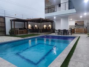 a swimming pool in the middle of a house at Cabaña Milagro Bonito in Santa Marta