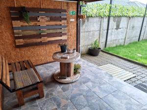 un patio con mesa, banco y pared en CABAÑA MI CASA AMOBLADA EN PUERTO MONTT, en Puerto Montt