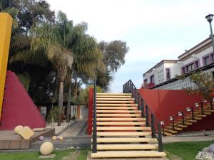 a set of stairs in a park with palm trees at HOTEL BOUTIQUE CASA DEL BOSQUE in Tlaxcala de Xicohténcatl