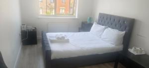 a bedroom with a bed with white sheets and pillows at H8 Room 3 Serene Home with 15 min walk to City Centre, Free car parking,Late Night Check In Anytime, 2 min walk to Bus Stop in Manchester
