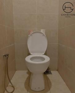 a bathroom with a toilet with a hose at Chariton Hotel Skudai Kiri in Johor Bahru