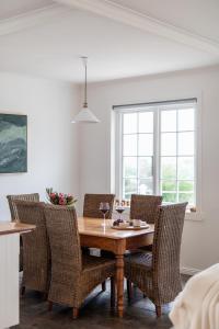 a dining room with a wooden table and chairs at Saltwood in Bridport