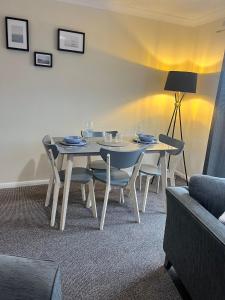 a dining room table and chairs with wine glasses on it at Pinecone Cottage in Frodingham