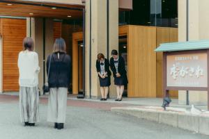 a group of women standing outside of a building at Tokigasane in Kaga +81 photos