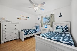 a bedroom with two beds and a ceiling fan at Sunshine Home and Romantic Vacation in Sarasota