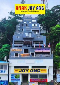 ein großes Gebäude mit einem Schild darüber in der Unterkunft Anak Jay Ang in Puerto Galera