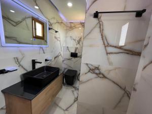 a bathroom with a sink and a mirror at Vila Laura in Ksamil