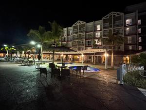 a hotel at night with chairs and tables and a building at São Pedro Thermas Resort in São Pedro
