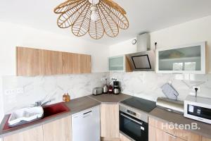 a kitchen with a sink and a ceiling at Green Haven T2 with Large Garden in Panazol