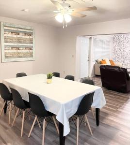 a dining room with a white table and chairs at Large 3 Bedroom Home 12 Minutes to Beach in Clearwater