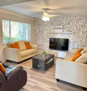 a living room with two couches and a fireplace at Large 3 Bedroom Home 12 Minutes to Beach in Clearwater