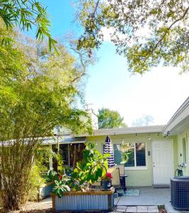 a yellow house with a porch and a patio at Large 3 Bedroom Home 12 Minutes to Beach in Clearwater