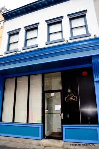 a store front with blue trim on a building at DC International Hostel 1 in Washington, D.C.