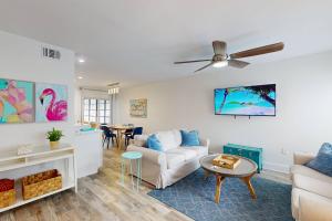 a living room with a couch and a table at 247-B - Madeira Beach Yacht Club in St Pete Beach