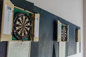 a dart board hanging on a wall next to boxes at Sofias Place w/ Massagechair in Tagaytay
