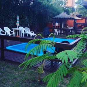 una piscina en un patio con mesa y sillas en Cabañas en Mar Azul en Balneario Mar Azul