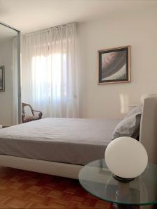a bedroom with a bed and a glass table at Mini Suite Cremona in Cremona