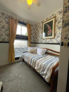 a bedroom with a bed and a window at Flora House Denver in Denver