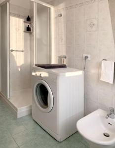 a washing machine in a bathroom next to a sink at Mini Suite Cremona in Cremona