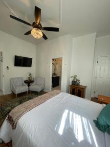 a bedroom with a bed and a ceiling fan at Flora House Denver in Denver